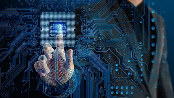 Digital hand touching a chip amid glowing circuit patterns