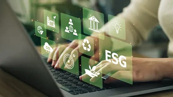 Hands typing on a laptop with floating ESG icons