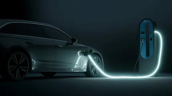 Electric car connected to a glowing charging station