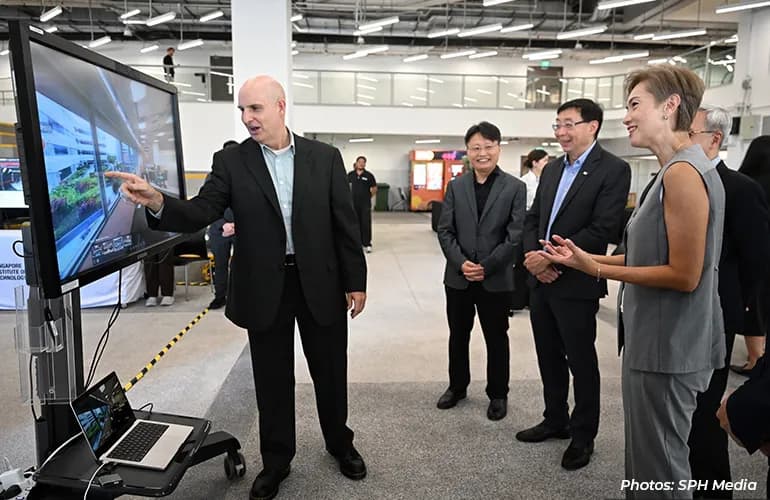 Group viewing a digital display during a technology demonstration.