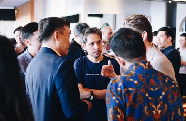 Group of people in lively conversation at a professional gathering