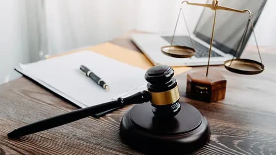 Gavel, scales of justice, and documents on a wooden desk