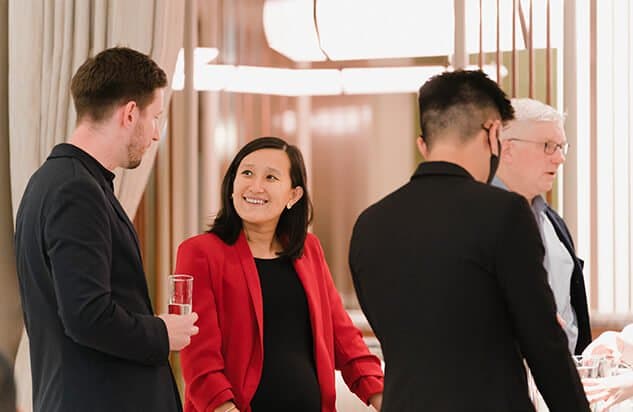 Group of two people in conversation in a warmly lit room