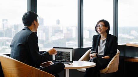 Two colleagues in discussion at work.