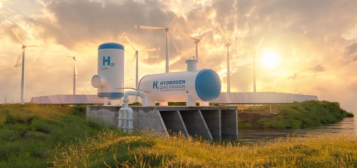 Hydrogen storage tanks labeled “H₂ Zero Emission” beside wind turbines and solar panels at sunset, representing clean renewable energy.