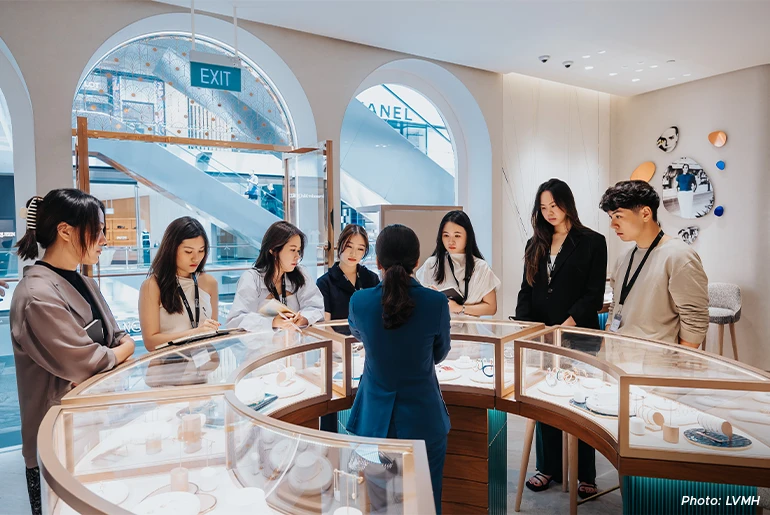 Avi and the 2024 LVMH SPRING Future Leaders Program graduate cohort at a store visit during induction week.
