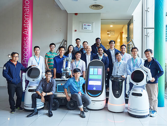 Dr Tan with the NCS Robotics Engineering team