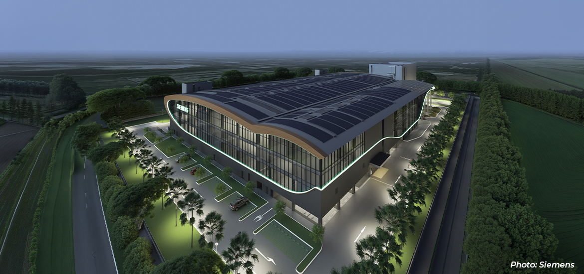 Architectural rendering of a modern Siemens industrial facility featuring rooftop solar panels, energy-efficient design elements, and landscaped surroundings, highlighting sustainable manufacturing and green infrastructure.