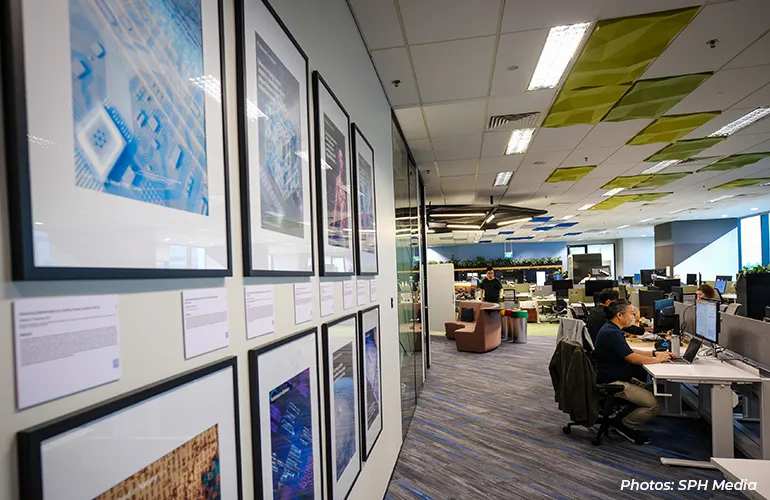 Open-plan office with employees working at desks.