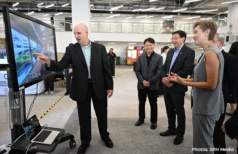 Group viewing a digital display during a technology demonstration.