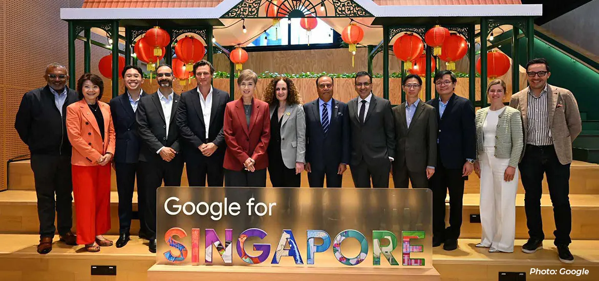 Group photo of officials and representatives standing behind a “Google for Singapore” sign with red lantern decorations in the background.