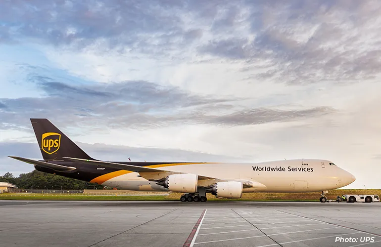 UPS cargo aircraft labeled “Worldwide Services” parked on an airport runway.