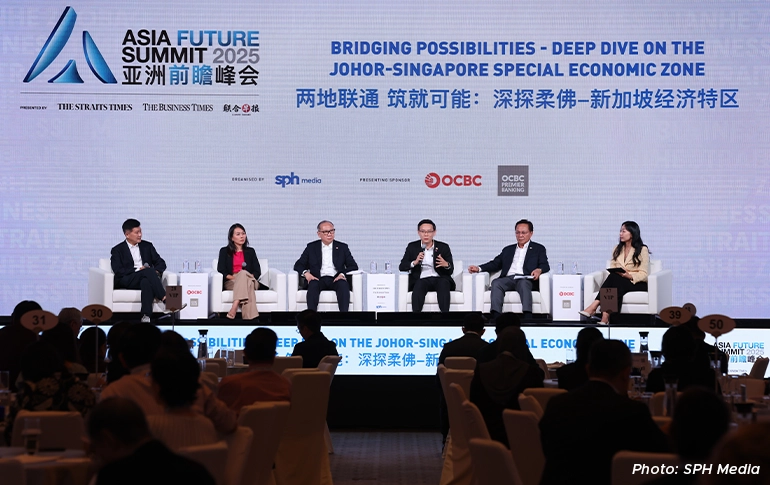 Panel discussion at the Asia Future Summit 2025 featuring speakers on stage discussing the Johor-Singapore Special Economic Zone before an audience.