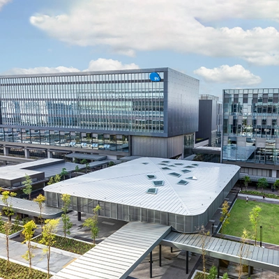 Modern research and innovation campus in Singapore with glass-fronted office buildings, landscaped walkways, and green spaces, highlighting advanced infrastructure for science, technology, and R&D (photo by JTC Corporation).