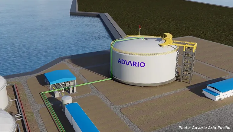 A digital rendering of an Advario Asia-Pacific storage tank facility featuring a large cylindrical tank beside a waterfront, connected by pipelines to nearby operational structures and buildings.