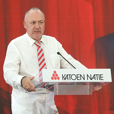 Chief executive for the Republic, Koen Cardon, speaking at a podium with the Katoen Natie logo, set against a red backdrop.