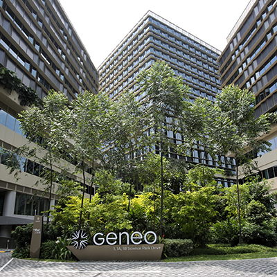 Exterior view of Geneo at Singapore Science Park, featuring a landscaped central courtyard with lush greenery surrounded by modern office and research buildings designed to support innovation and collaboration.