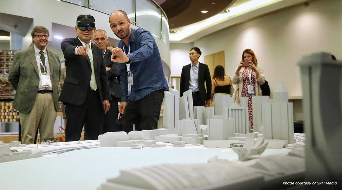 Deputy Prime Minister Heng Swee Keat trying the augmented reality goggles which show the behaviour of wind in the city, at the Create Symposium 2023, where he also delivered a speech. 