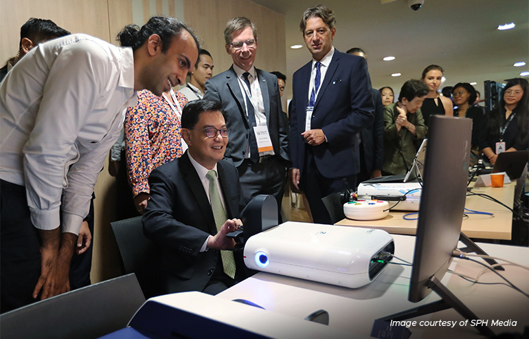 Deputy Prime Minister Heng Swee Keat trying ReHandyBot during his tour at the Create Symposium 2023. 