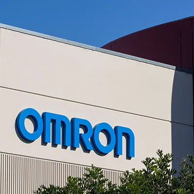 OMRON company logo displayed on the exterior wall of a building.