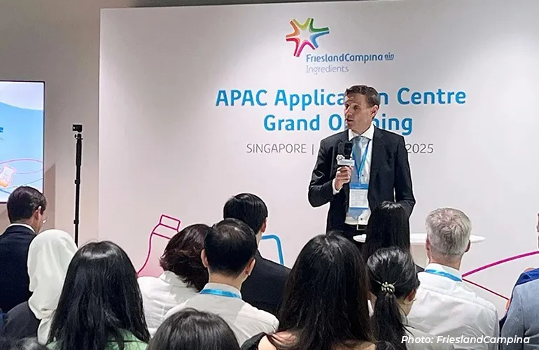 Man speaking to an audience at the FrieslandCampina APAC Application Centre grand opening event.