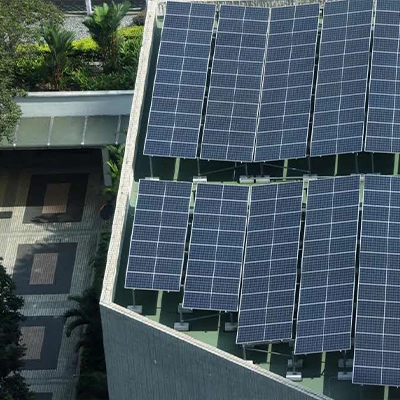 Aerial view of rooftop solar panels on a Singapore building, showcasing urban renewable energy adoption with pedestrians walking below.