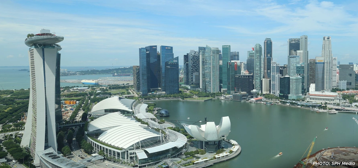Aerial view of Marina Bay Sands and the Singapore skyline with modern skyscrapers and waterfront.