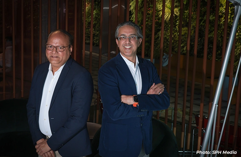 British International Investment managing director Srini Nagarajan and FAST-P chief executive Munib Madni at a solar panel farm.