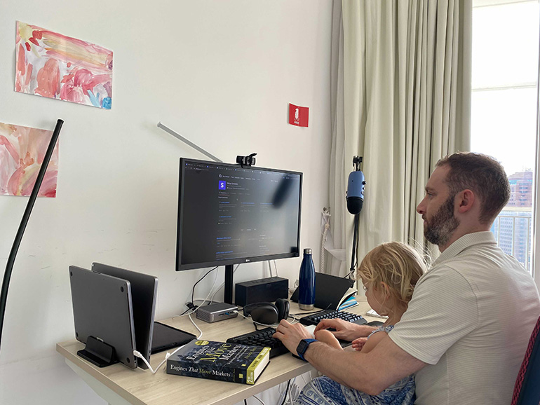 Noah working from home with his daughter