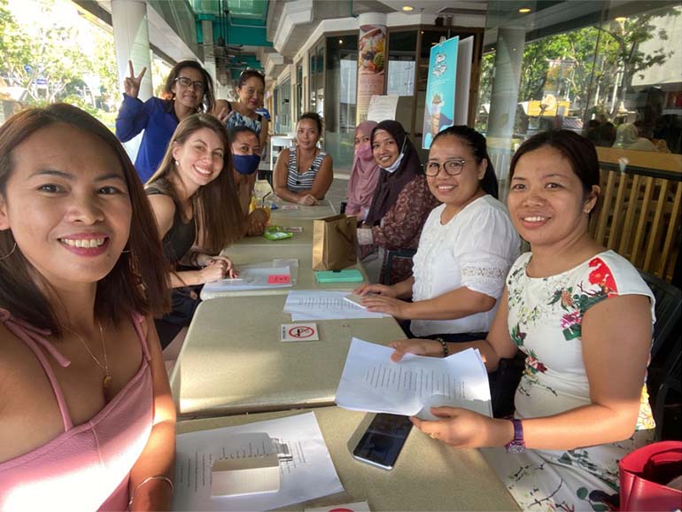Marina teaching a writing class to migrant workers at HOME