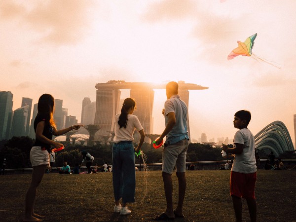 people at marina barrage flying a kite