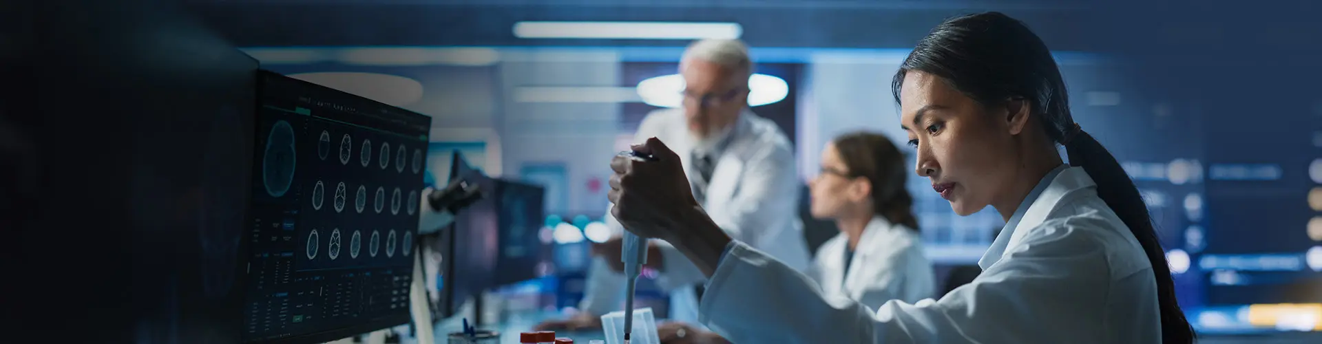 Scientists working in a high-tech laboratory with advanced imaging screens, conducting medical research and diagnostics, symbolizing innovation in healthcare and biomedical science.