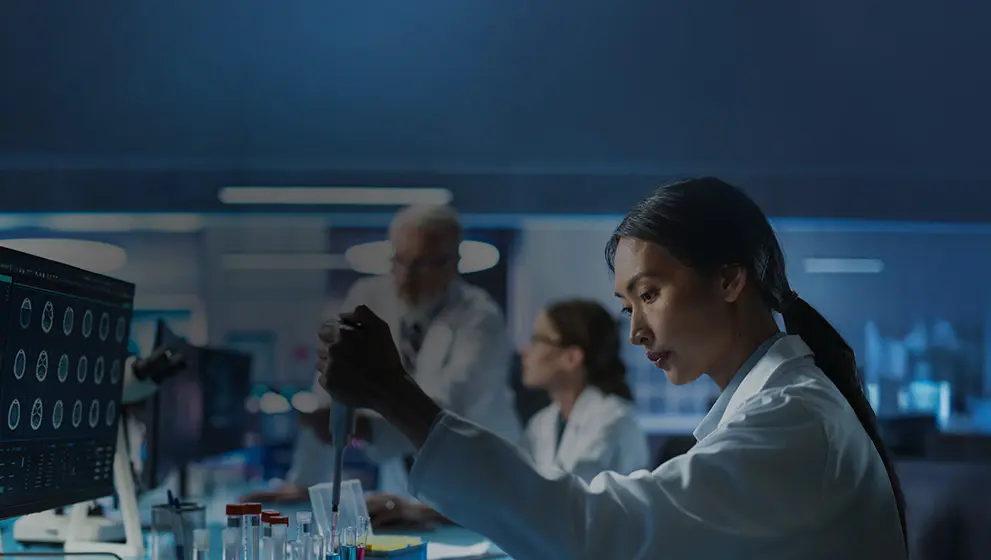 Scientists working in a high-tech laboratory with advanced imaging screens, conducting medical research and diagnostics, symbolizing innovation in healthcare and biomedical science.