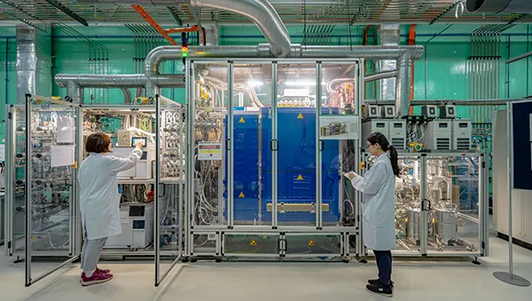 Solar panels with city skyline at sunset, symbolizing a rising R&D powerhouse in clean energy.