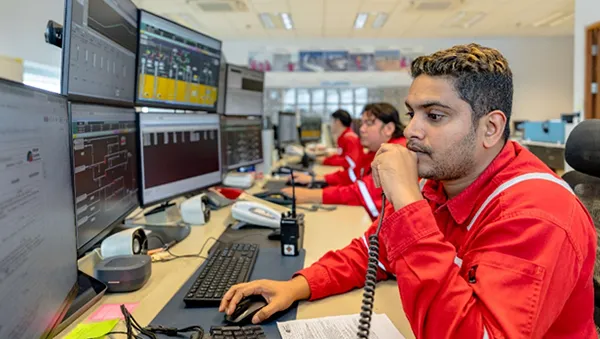Scientist working with microscope in modern lab, representing a strong talent pipeline.