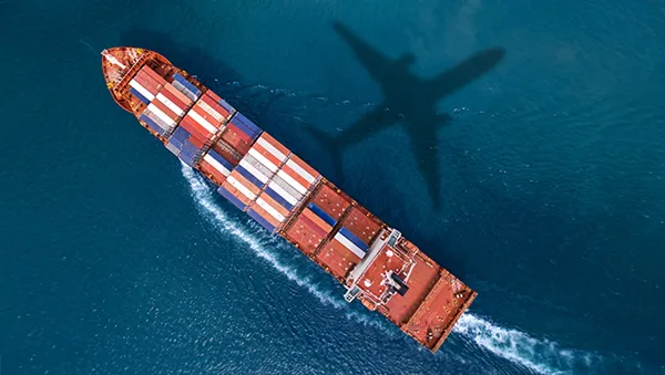 Expansive solar farm stretching towards a modern city skyline at sunset, representing the shift to low-carbon energy and urban sustainability.