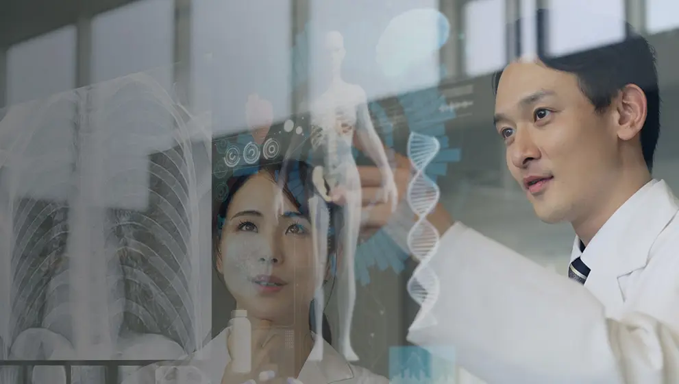 Doctors analyzing digital medical data on a transparent screen.