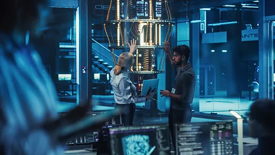 Researchers collaborate inside a high-tech laboratory, reviewing data on digital screens while examining advanced computing equipment in a futuristic innovation and research hub.