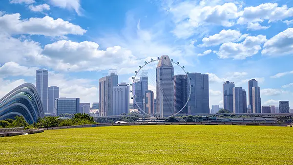 Singapore skyline with the Singapore Flyer and lush greenery, symbolizing a clean, sustainable national climate and urban livability.