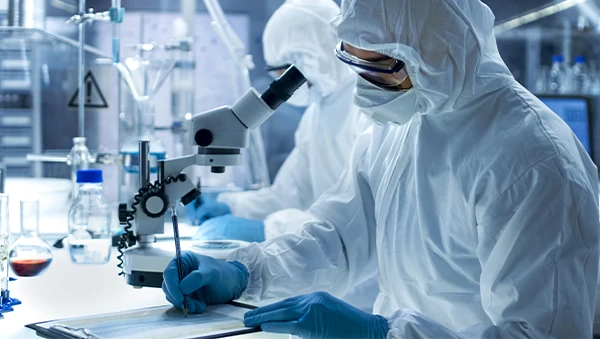 Scientists in full protective suits conducting research in a high-tech laboratory environment, highlighting advanced R&D infrastructure.