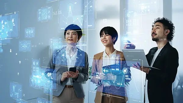 Software developer working at a multi-monitor setup with code on screens, illustrating a robust talent ecosystem in the tech industry.