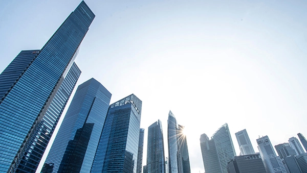 Modern skyscrapers in a central business district under clear skies, representing a business-driven environment.