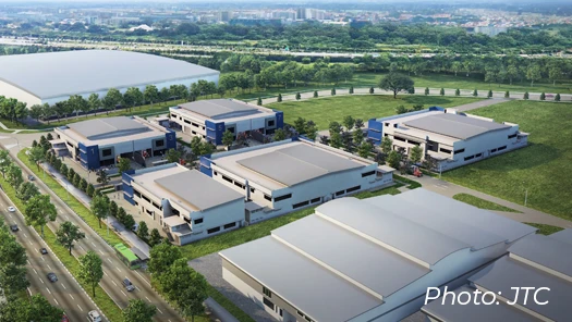 Singapore industrial estate aerial view featuring modern JTC high-tech industrial buildings, green landscaping, and surrounding road infrastructure.