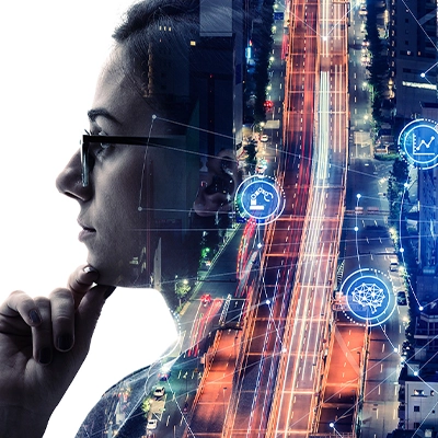 Double exposure of a thoughtful person and a smart city at night, overlaid with digital icons representing connectivity, cloud computing, data, and wireless technology.