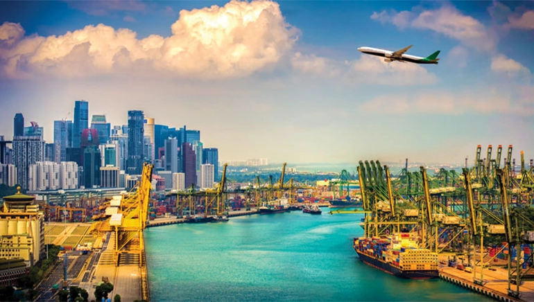 Vibrant view of Singapore’s port with colorful shipping containers, cranes, and high-rise city skyline, as an airplane flies above under a bright sky.