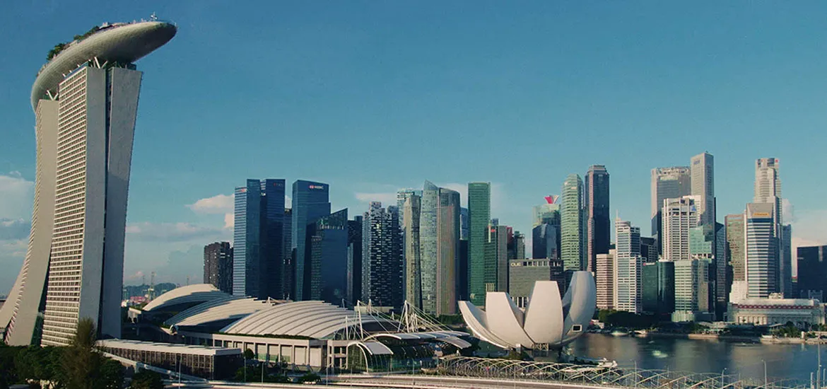 Singapore skyline featuring Marina Bay Sands, surrounding skyscrapers, and the waterfront.