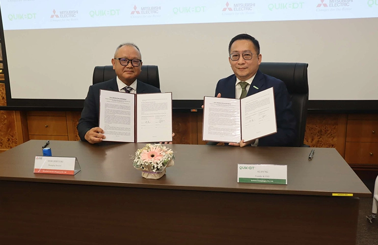 Hideyuki Mori of Mitsubishi Elevator Singapore (left) and Alan Ng of QuickBot Technologies at a strategic partnership signing ceremony in Singapore.