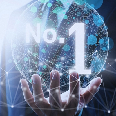 Businessperson holding a digital globe with “No. 1” displayed over a connected network graphic.