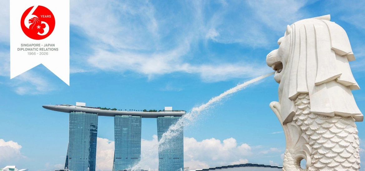 The Merlion statue in Singapore spouting water with Marina Bay Sands in the background, alongside a “60 Years Singapore–Japan Diplomatic Relations (1966–2026)” emblem.