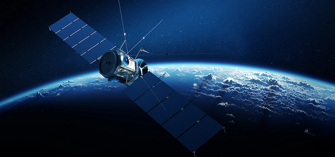 Satellite orbiting above Earth with solar panels extended, set against the backdrop of space and the planet’s curved horizon.